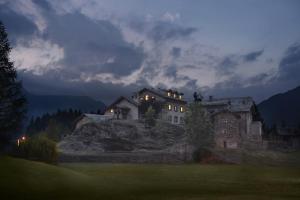 a house sitting on top of a hill at night at Casa Alpina San Luigi in Campodolcino