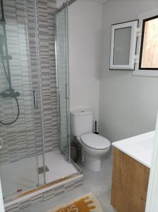 a bathroom with a toilet and a glass shower at COOL! 5' to metro. 15' to Center/beach by metro. in Santa Coloma de Gramanet