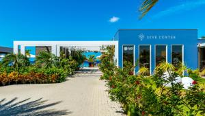 a walkway in front of a building with flowers at Delfins Beach Resort in Kralendijk