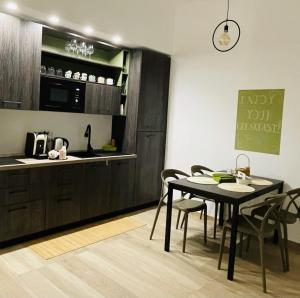 a kitchen and dining room with a table and chairs at La Titina Sella in Bari
