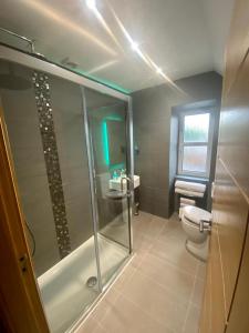 a bathroom with a shower and a toilet and a sink at Ravelston House in Musselburgh