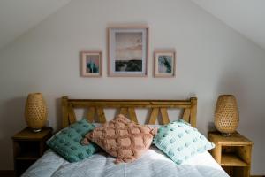a bedroom with a bed with pillows on it at Modern self catering apartment, Miltown Malbay in Milltown Malbay