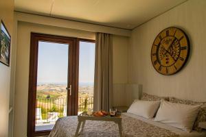 a bedroom with a large clock on the wall and a bed at B&B & SPA Novantadieci Club in Atri