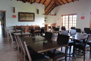 a dining room with wooden tables and chairs at Fazenda Itaygua Hotel in Ribeirão Preto +49 photos
