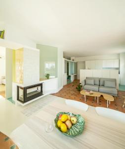 a living room with a table with a bowl of fruit at Casa Chirimoyo in Motril