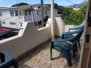a pair of chairs sitting on a balcony at Adorable 2bedroom homestay in Beau Bassin