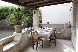 a table and chairs sitting on a patio at Villa Salinara in Marsala