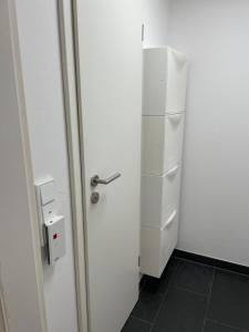 a white door in a room with a refrigerator at Studio in Wilhelmshaven