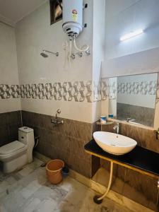 a bathroom with a sink and a toilet at Ideal Guest House in Jaisalmer