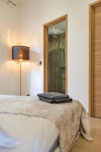 a bedroom with a bed and a glass shower at SUPERBE APPARTEMENT AVEC BALCON PROCHE MONACO in Beausoleil +10 photos