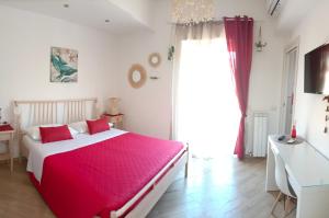 a bedroom with a large bed with a red blanket at Casa Dharma in Civitavecchia