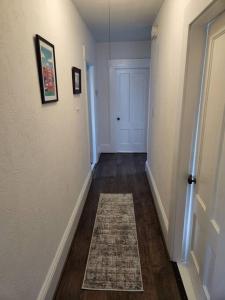 a hallway with a door and a rug on the floor at Lovely two bedroom apartment with free parking in Manchester