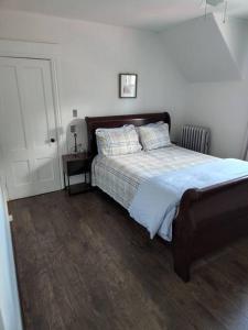 a bedroom with a large bed with a wooden floor at Lovely two bedroom apartment with free parking in Manchester