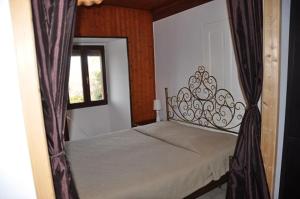 a bedroom with a bed with a window and a bed frame at Appartement dans la vieille ville, en face du château in Annecy