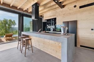 a kitchen with a large counter with stools in front at Villa Terra Motovun in Motovun
