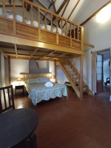 a bedroom with a bunk bed and a staircase at Casona Buenavista Andahuaylillas in Andalmailillas