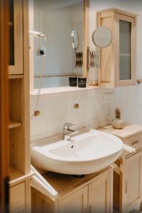 a bathroom with a white sink and a mirror at Haus Hanni Zarrentin am Schaalsee in Zarrentin