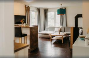 a living room with a couch and a table at Haus Hilde Zarrentin am Schaalsee in Zarrentin