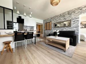 a kitchen and living room with a brick wall at "Rue Longue" Vue Mer, Spacieux, Rénové in Menton