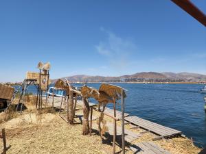 a view of a body of water with a dock at Hanan Pacha Lodge in Puno