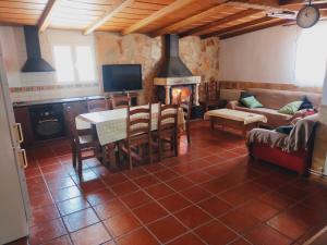 a living room with a table and a fireplace at Casa rural cascales in Cervera del Llano