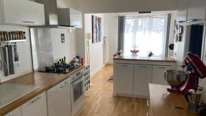 a kitchen with white cabinets and a stove top oven at Maison entière au calme à Saint-Max/Nancy in Saint-Max