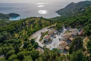 an aerial view of a house on a hill next to the water at Horizon Ionian Villas in Perdika