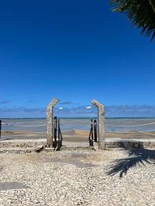 un grupo de esculturas en una playa cerca del océano en MARAGOGI FLAT BEIRA MAR en Maragogi