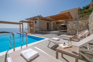 a luxury villa with a swimming pool and a villa at Horizon Ionian Villas in Perdika