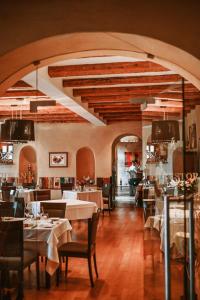 a restaurant with tables and chairs in a room at Heritage Hotel Kukuriku in Kastav