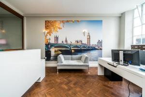 a living room with a painting of a bridge at Equitable Hotel in Woolwich