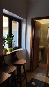 a bathroom with a table and two chairs and a window at Casa Arion in Băile Herculane +57 photos