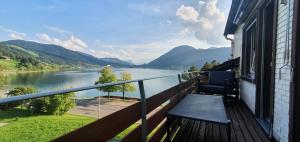 a balcony with a view of a river and mountains at Ferienwohnung Ägerisee in Oberägeri