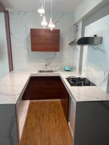 a kitchen with a stove and a counter top at Hotel Residencia SOGU in Ayacucho