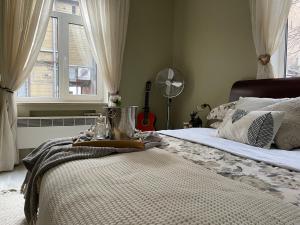 een slaapkamer met een bed, een ventilator en een raam bij Exquisite & Steps to center 1Br Apt with Free Parking in Rīga