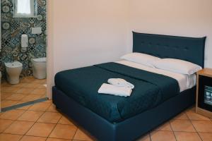 a bedroom with a bed with two towels on it at Dal Patricano in Frosinone