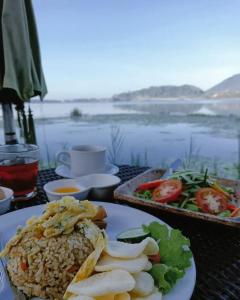 a table with a plate of food on a table with a view at Glamour camping bedugul in Bedugul