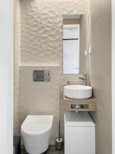 a bathroom with a white toilet and a sink at Sea Light Apartment Sesimbra. 2 bedrooms, 6 guests in Sesimbra