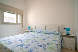 カヴァ・ダリーガにあるMaredaligaの白いベッドルーム(ベッド1台、窓付)