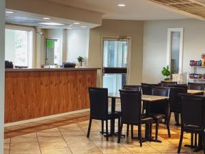 a waiting room with a table and chairs at Ramada by Wyndham Lumberton in Lumberton