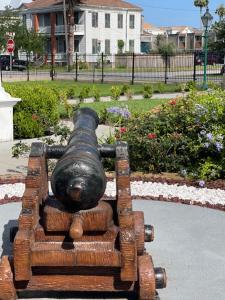 a statue of a gun sitting on a bench at The George Manor in Galveston