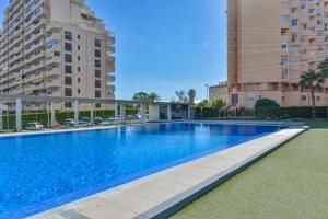 a swimming pool in the middle of two tall buildings at Estudio Loft Horizonte Playa Fossa Calpe in Calpe