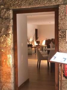 a view of a living room with a table and chairs at Quinta de Barbêdo in Caniçada