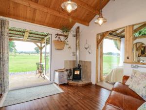 an open living room with a fireplace and a porch at The Jenny Wrennery in Rugeley
