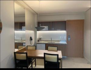 a kitchen with a table and chairs and a dining room at Salinas Exclusive Resort in Salinópolis