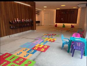a room with a table and chairs on a rug at Salinas Exclusive Resort in Salinópolis