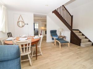 a dining room and living room with a table and chairs at The Holt in Sidmouth