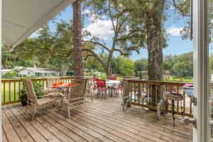 a wooden deck with chairs and a table on it at Family Forest Retreat, Paradise at Point Pleasant! 