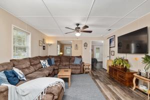 a living room with a couch and a flat screen tv at Family Forest Retreat, Paradise at Point Pleasant! 