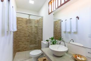 a bathroom with a sink and a toilet and a shower at Casa Luar Trancoso in Trancoso